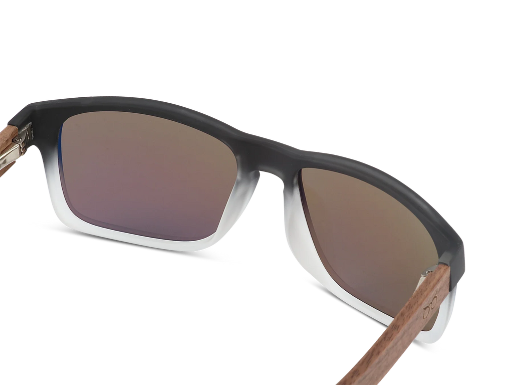 Sunglasses with brown gradient lenses and wooden arms on a white background