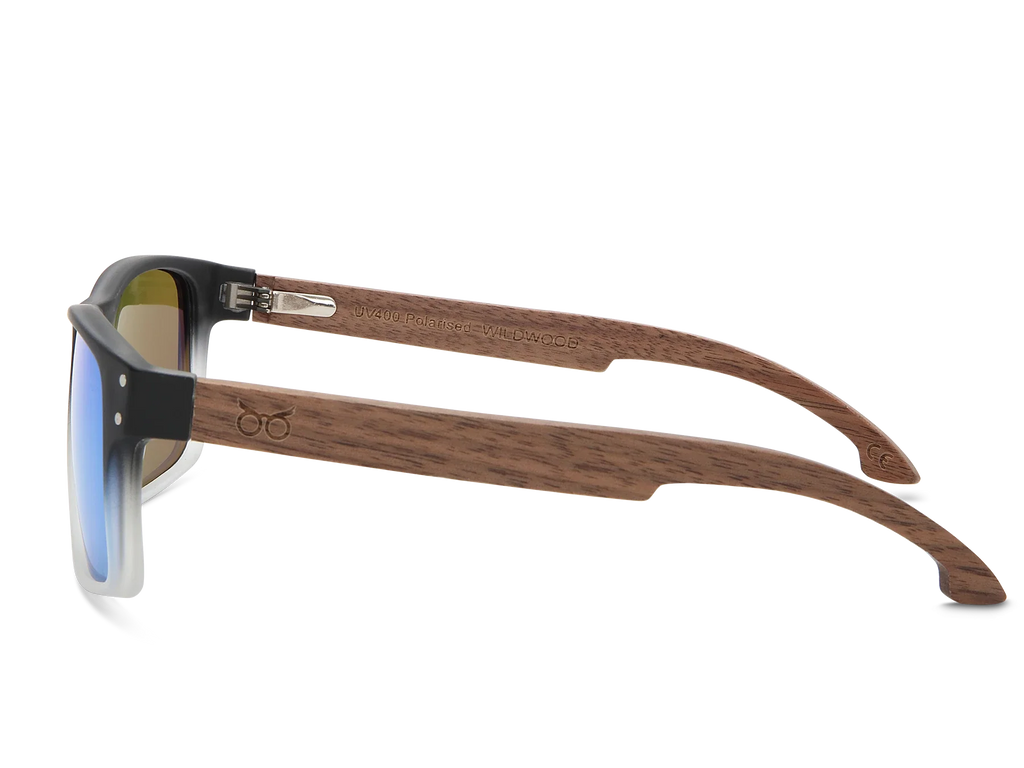 Sunglasses with wooden frame and reflective lenses on a white background