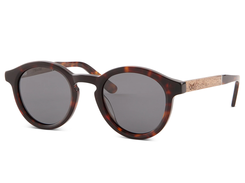 Sunglasses with tortoiseshell frame and dark lenses on a white background