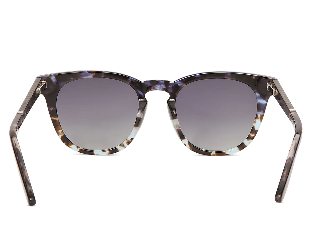 Sunglasses with tortoiseshell frame and dark lenses on a white background