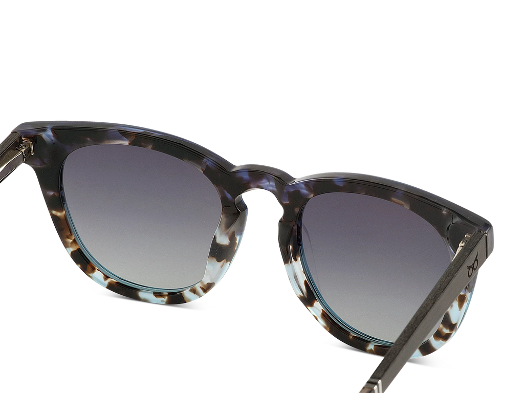 Sunglasses with tortoiseshell frame and dark lenses on a white background