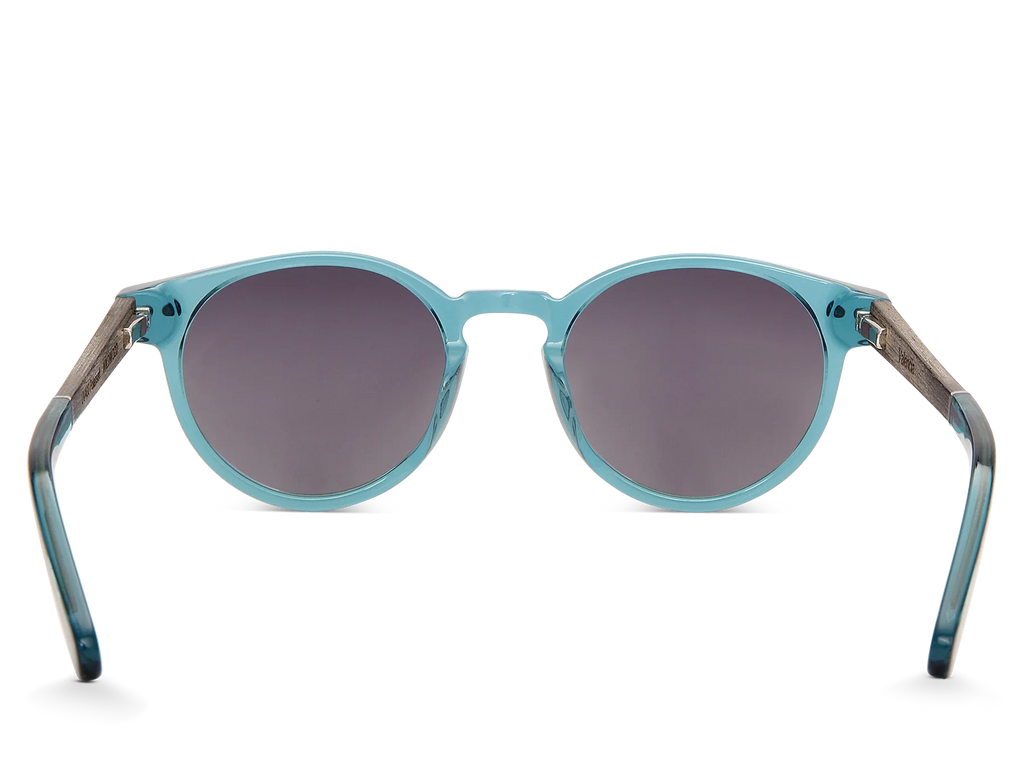 Blue sunglasses with dark lenses on a white background