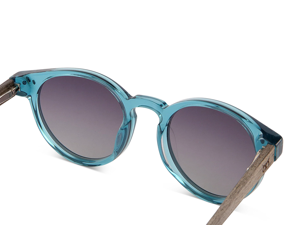 Blue sunglasses with dark lenses on a white background